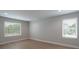 Bright bedroom with light walls, wood floors, and large windows providing ample natural light at 304 Cabarrus W Ave, Concord, NC 28025