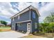 New construction home with navy siding, a white door, and a well-manicured lawn and garden at 304 Cabarrus W Ave, Concord, NC 28025