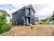 Modern new construction home with navy siding, a well-manicured lawn, and a welcoming front porch at 304 Cabarrus W Ave, Concord, NC 28025
