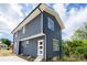 Charming new construction home with navy siding, a white door, and a well-manicured lawn and plantings at 304 Cabarrus W Ave, Concord, NC 28025