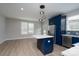Bright kitchen featuring a center island, stainless steel refrigerator, and sleek modern design at 304 Cabarrus W Ave, Concord, NC 28025