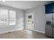 Bright kitchen area with wood-look flooring, stainless steel refrigerator, and a door to the exterior at 304 Cabarrus W Ave, Concord, NC 28025