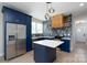 Stylish kitchen with blue cabinets, stainless steel appliances, and a modern backsplash at 304 Cabarrus W Ave, Concord, NC 28025