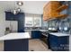 Beautiful kitchen with stainless steel appliances, modern lighting, and elegant blue cabinets at 304 Cabarrus W Ave, Concord, NC 28025