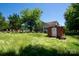 View of the overgrown backyard with storage shed at 315 E Washington Ave, Bessemer City, NC 28016