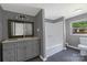 A well-lit bathroom is equipped with a vanity, tub, and toilet at 315 E Washington Ave, Bessemer City, NC 28016