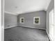 Bright bedroom featuring plush carpeting and two windows at 315 E Washington Ave, Bessemer City, NC 28016