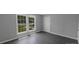 Bright bedroom with neutral walls, modern gray flooring, and natural light, creating a comfortable living space at 315 E Washington Ave, Bessemer City, NC 28016