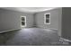 Spacious bedroom with plush carpeting and abundant natural light from two windows at 315 E Washington Ave, Bessemer City, NC 28016