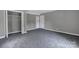 Neutral bedroom featuring plush carpet, closet, and white doors at 315 E Washington Ave, Bessemer City, NC 28016
