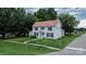 Two-story house featuring a classic design, surrounded by a well-maintained lawn, sidewalk and mature trees at 315 E Washington Ave, Bessemer City, NC 28016