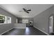 Spacious living room featuring an open concept, neutral walls, and modern gray flooring with a peek of the kitchen at 315 E Washington Ave, Bessemer City, NC 28016