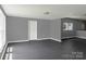 Bright living room boasting neutral walls and modern gray flooring, complemented by natural light through the windows at 315 E Washington Ave, Bessemer City, NC 28016