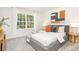 Inviting bedroom with large windows that offer natural light, stylish decor, and a comfortable bed with decorative pillows at 3734 Coleman Dr, Charlotte, NC 28215