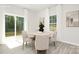Dining area with a sliding glass door and large windows offering scenic backyard views at 3734 Coleman Dr, Charlotte, NC 28215