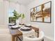 Elegant dining area with a wooden table, stylish seating, and contemporary artwork on the wall at 3734 Coleman Dr, Charlotte, NC 28215
