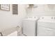 Functional laundry room equipped with a washer, dryer, and decorative wall art, creating a practical and visually appealing space at 3734 Coleman Dr, Charlotte, NC 28215