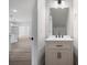 Bright bathroom with a stylish vanity and a large mirror, adjacent to an open living area at 3926 Litchfield Rd, Charlotte, NC 28211