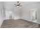 Bright bedroom with a ceiling fan, featuring an ensuite bathroom and walk-in closet at 3926 Litchfield Rd, Charlotte, NC 28211