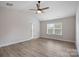 Spacious bedroom featuring a vaulted ceiling, ceiling fan, and a large window at 3926 Litchfield Rd, Charlotte, NC 28211