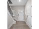 Light and bright hallway with a white front door and stairs with iron balusters at 3926 Litchfield Rd, Charlotte, NC 28211