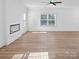 Living room features a modern fireplace, neutral walls, hardwood floors, and a ceiling fan at 3926 Litchfield Rd, Charlotte, NC 28211