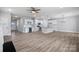 Spacious living room with a ceiling fan and an open floor plan into the kitchen at 3926 Litchfield Rd, Charlotte, NC 28211