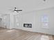 Living room features modern fireplace, neutral walls, hardwood floors, and a ceiling fan at 3926 Litchfield Rd, Charlotte, NC 28211