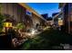 The backyard offers meticulously manicured landscaping, ambient lighting, and a peaceful outdoor retreat at 4014 Pleasant Run Dr, Stallings, NC 28227