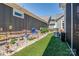 Beautifully landscaped backyard featuring artificial turf, stone accents, and flowering plants at 4014 Pleasant Run Dr, Stallings, NC 28227