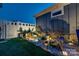 Landscaped backyard featuring decorative rocks, ambient lighting, and a small water feature, offering a serene outdoor space at 4014 Pleasant Run Dr, Stallings, NC 28227