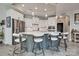 Modern kitchen with white cabinets, stainless steel appliances, and seating at the island at 4014 Pleasant Run Dr, Stallings, NC 28227