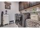 Well-equipped laundry room with modern washer and dryer and ample storage at 4014 Pleasant Run Dr, Stallings, NC 28227