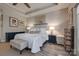 Bright main bedroom with tray ceiling, luxury bedding, and ensuite bathroom access at 4014 Pleasant Run Dr, Stallings, NC 28227