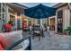 Inviting outdoor patio with comfortable seating under a large umbrella, perfect for entertaining guests at 4014 Pleasant Run Dr, Stallings, NC 28227