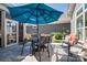 Outdoor patio with dining table, chairs, and a vibrant blue umbrella at 4014 Pleasant Run Dr, Stallings, NC 28227