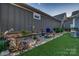 Picturesque side yard with rock garden, water feature, landscape lighting, and artificial turf at 4014 Pleasant Run Dr, Stallings, NC 28227