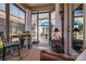 Relaxing sunroom features views of outdoor patio with table, chairs, and shade umbrella at 4014 Pleasant Run Dr, Stallings, NC 28227