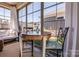 Bright sunroom features large windows with views of the outdoors and cozy seating at 4014 Pleasant Run Dr, Stallings, NC 28227