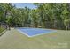 Community tennis court with lush green surroundings and benches for relaxing at 4014 Pleasant Run Dr, Stallings, NC 28227