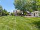 Extensive backyard featuring manicured lawn, mature trees, gazebo, and outdoor entertaining spaces at 420 S Cedar St, Lincolnton, NC 28092