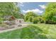 Expansive backyard with lush lawn, mature trees, charming gazebo, and convenient storage sheds at 420 S Cedar St, Lincolnton, NC 28092