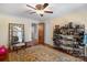 Bright bedroom with a full-length mirror, hardwood floors, ceiling fan, and convenient shoe storage rack at 420 S Cedar St, Lincolnton, NC 28092
