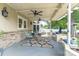 Inviting covered patio features ceiling fans, stylish seating, and exterior stone accents for relaxed outdoor living at 420 S Cedar St, Lincolnton, NC 28092