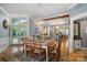 Open dining area with a rustic table, hardwood floors, and access to the backyard patio at 420 S Cedar St, Lincolnton, NC 28092