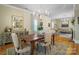 Elegant dining room with hardwood floors, a chandelier, and a view into the living room at 420 S Cedar St, Lincolnton, NC 28092