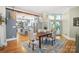 Spacious dining area with hardwood floors, a rustic table, and a view into the modern kitchen at 420 S Cedar St, Lincolnton, NC 28092