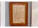 Close-up of a framed historical document on a painted wall with white trim at 420 S Cedar St, Lincolnton, NC 28092