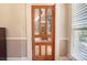Hallway featuring decorative glass-paned wood door and neutral wall colors at 420 S Cedar St, Lincolnton, NC 28092