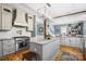 Bright kitchen with stainless steel appliances, an island with marble countertop, and hardwood floors at 420 S Cedar St, Lincolnton, NC 28092
